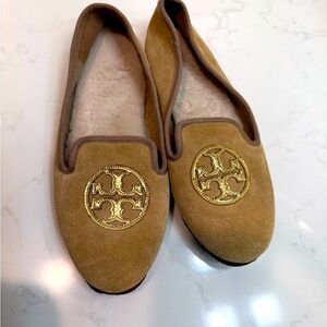 Tory Burch tan Suede Slippers with Gold Emblem 
and cozy comfy sheepskin lining.